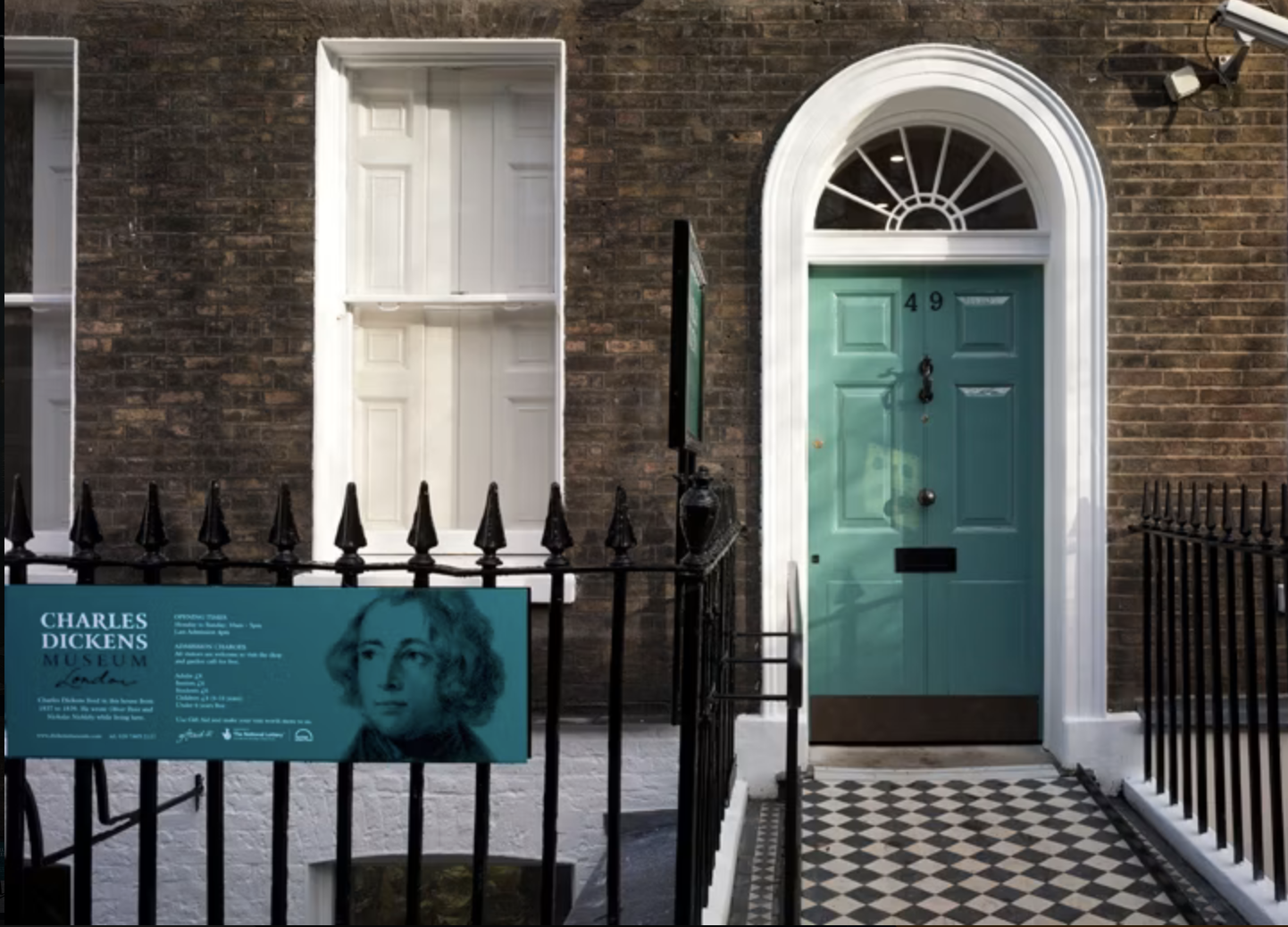 A turquoise door and Charles Dickens Museum sign in London